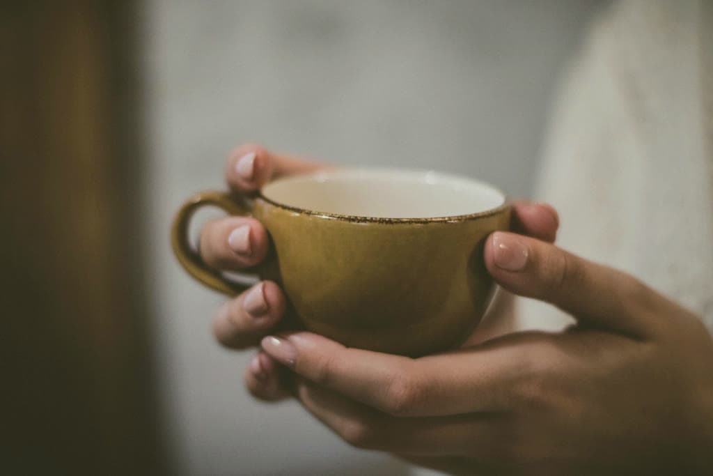 Hands holding a warm cup